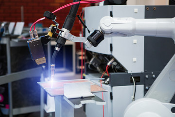 Poster - Automatic welding robot in a modern factory in operation. 