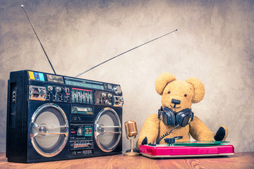 Wall Mural - retro teddy bear toy with headphones at the dj turnable mixing console, classic mic, old cassette gh