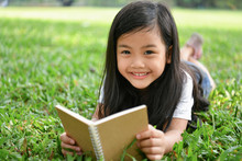 Education Concepts. The Girl Is Reading A Book In The Garden. Beautiful Girl Is Seriously Studying. Beautiful Girls Are Happy Learning.