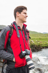 Brunette man on hike withcamera around his neck
