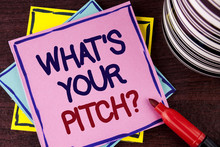 Word Writing Text What Is Your Pitch Question. Business Concept For Present Proposal Introducing Project Or Product Written On Pink Sticky Note Paper On Wooden Background Cup And Marker Next To It