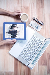 Fototapete - Business graphs against overhead of feminine hands holding tablet and coffee