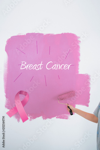 Woman Painting Her Wall Pink Against Pink Breast Cancer Awareness