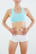 © WavebreakmediaMicro - Mid section of a fit woman in sportswear with hands on belly