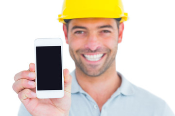Poster - Portrait of smiling handyman showing smart phone