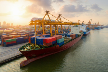 Containers yard in port congestion with ship vessels are loading and discharging operations of the transportation in international port.Shot from drone.