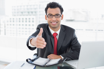 Poster - Businessman offering a handshake at office desk