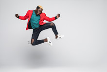 Full Length Portrait Of A Cheerful Afro American Man Jumping Isolated On A White Background