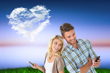 Poster - Attractive couple using their smartphones against cloud heart