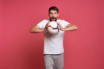 man squeezes a soccer ball