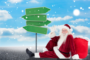 Wall Mural - Santa sits leaned on his bag and waves against illustration of empty signposts