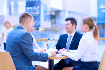 Wall Mural - Group of happy young business people in a meeting at office. Group of happy young business