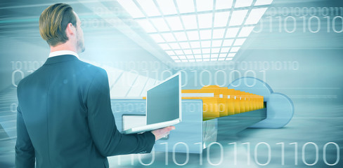 Poster - businessman looking up holding laptop against composite image of cloud computing drawer