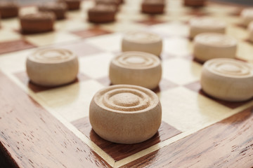 Wall Mural - wooden draughts board game on brown table