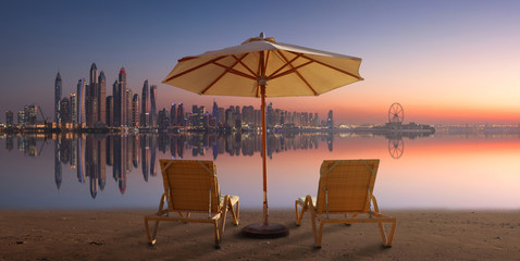 Wall Mural - Beautiful terrace with two chairs and an umbrella with Dubai Marina view