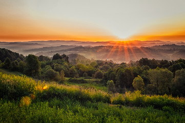 Amazing morning sunrise over the green hills