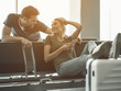 © Yakobchuk Olena - Beaming male speaking with glad female. He holding mobile in arm while sitting on chair in lounge zone. Glad couple telling indoor concept