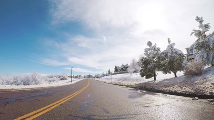 Wall Mural - Driving on suburban road after the Sping snow storm