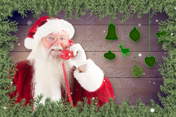 Wall Mural - Santa claus on the phone against christmas themed frame