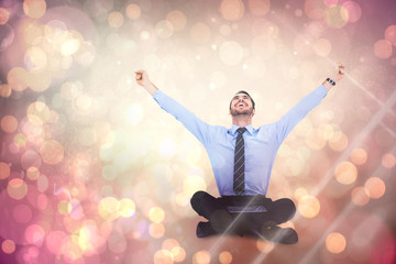 Sticker - Businessman cheering with tablet sitting on floor against yellow abstract light spot design