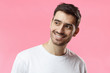 © Damir Khabirov - Closeup headshot of young European Caucasian man pictured isolated on pink background smiling happily, looking aside as if waiting for mate or girlfriend, feeling positive, relaxed and joyful