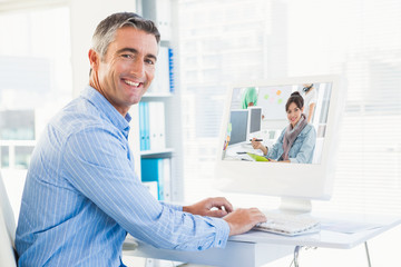 Aufkleber - Artist drawing something on graphic tablet with colleagues behind against smiling man typing on keyboard and looking at camera