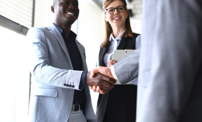 Business people shaking hands, finishing up a meeting.