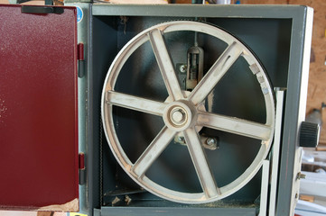 Wall Mural - Detailed image of an opened band saw in a little carpentry shop.