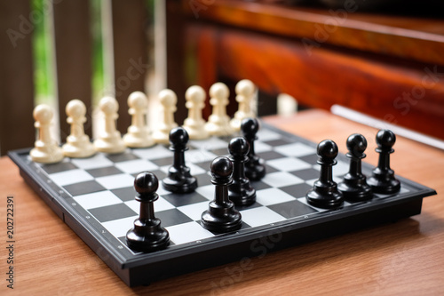 Fotografia, Obraz Chess black pawn invade (attack) white pawn for leader background or texture - Business & Strategy Concept