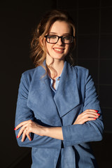 business portrait of a woman in a business suit with a folder for papers