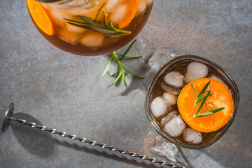 Wall Mural - Ice cold tea in pitcher and glass with rosemary garnish