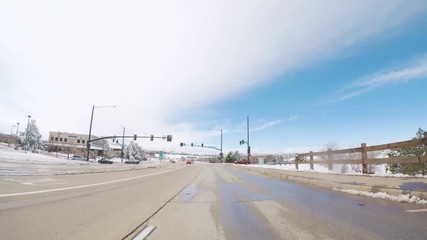 Wall Mural - Driving on suburban road after the Sping snow storm