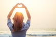 © yurakrasil - beautiful and young woman depicts the heart Rukmi on the beach