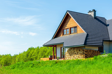 Side view of a house on green meadow during spring in countryside landscape of Poland near Krakow city