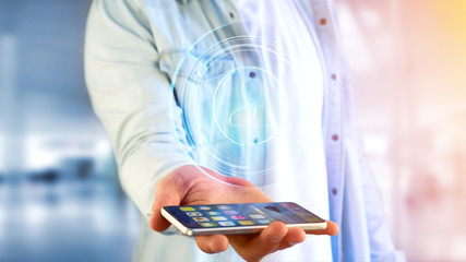 Poster - Businessman using a smartphone with a Shinny technologic network contact button  - 3d render