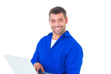 Poster - Portrait of smiling male mechanic using laptop