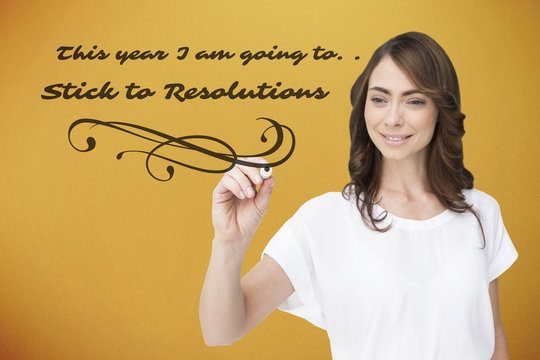 Smiling businesswoman holding marker against yellow background with vignette