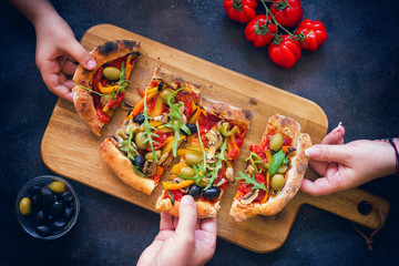 Family sharing fresh homemade vegetarian pizza 