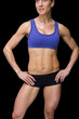 © WavebreakmediaMicro - Strong woman posing in sports bra and shorts with hands on hips