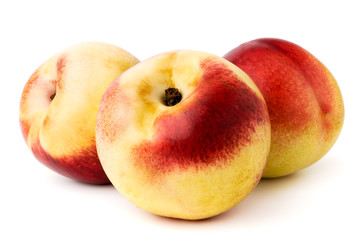 Wall Mural - Three ripe nectarines on a white. isolated.