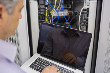 Aufkleber - Man sitting in front of a laptop doing server maintenance