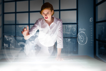 Poster - Redhead businesswoman using interactive desk against room with large window showing city