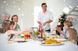 © vectorfusionart - Composite image of Family enjoying Christmas meal at dining table against snow