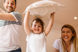 © Nebojsa - Cute little girl is playing with pillows with her parents