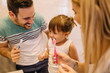 © Nebojsa - Young parents are showing to their daughter the best way to brush teeth