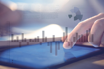 Poster - business interface with graphs and data against businessman using laptop and tablet at desk