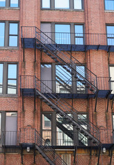 Wall Mural - ancient brick building with fire ladder on the wall