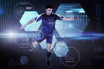 Poster - Football player in blue kicking against shiny hexagons on black background