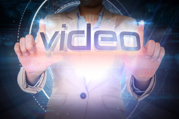 Poster - Businesswoman presenting the word video against black background with glowing circle