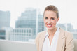© WavebreakmediaMicro - Smiling gorgeous businesswoman working on her laptop